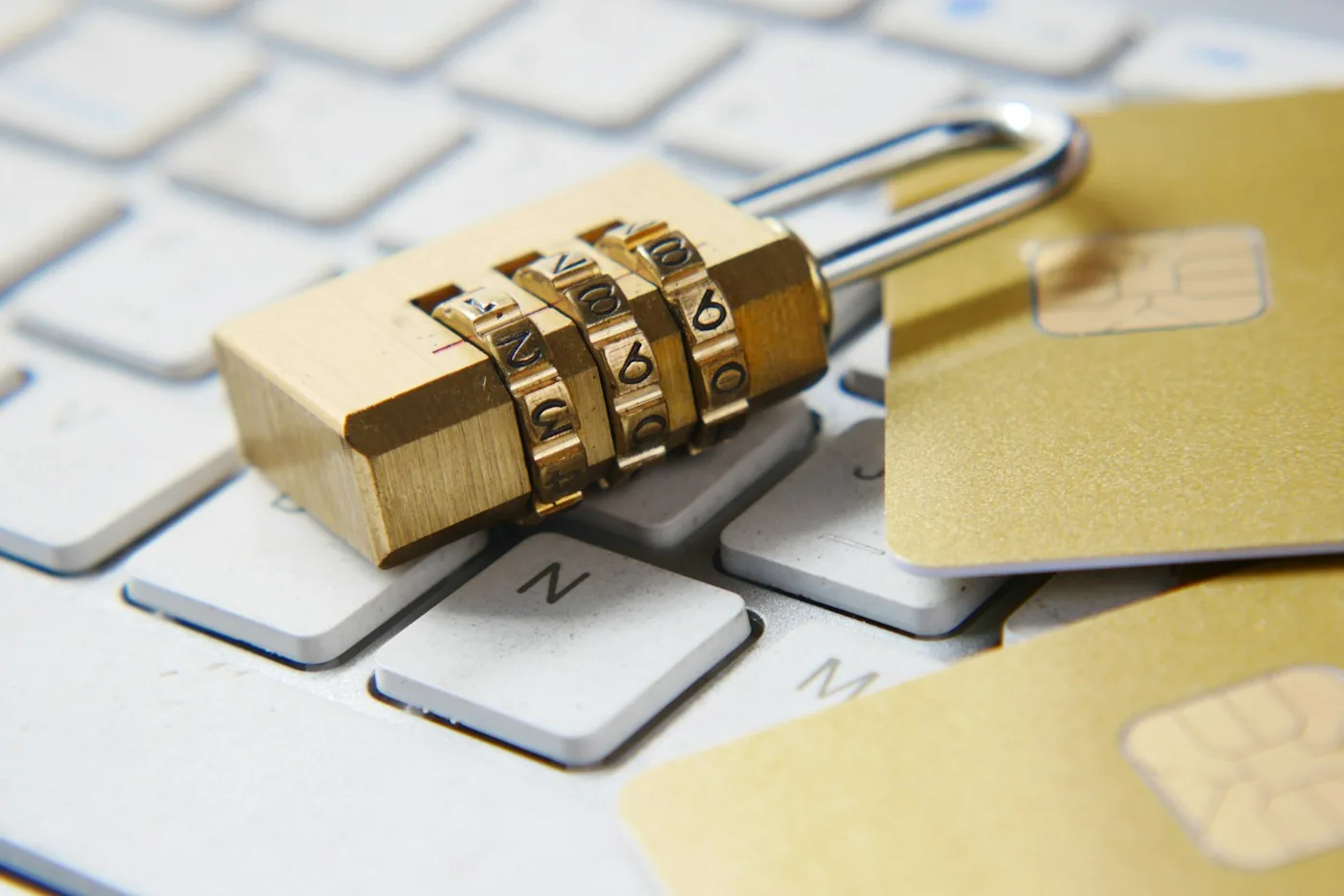 A combination padlock resting on a computer keyboard.