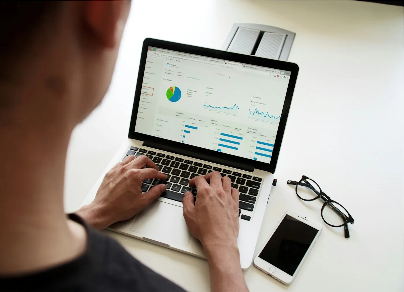A person using an analytics dashboard on a laptop.