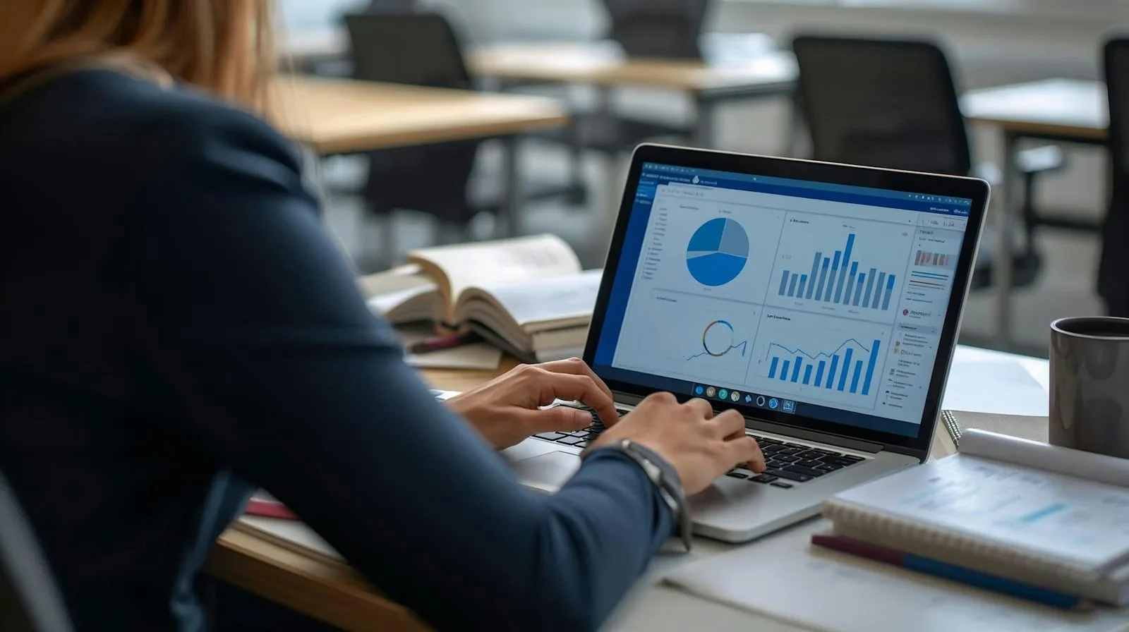 A professional reviewing charts on a laptop.