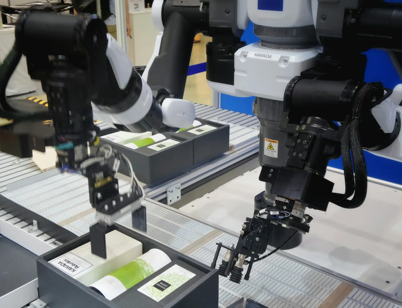 Industrial automation equipment handling parts on a work surface.