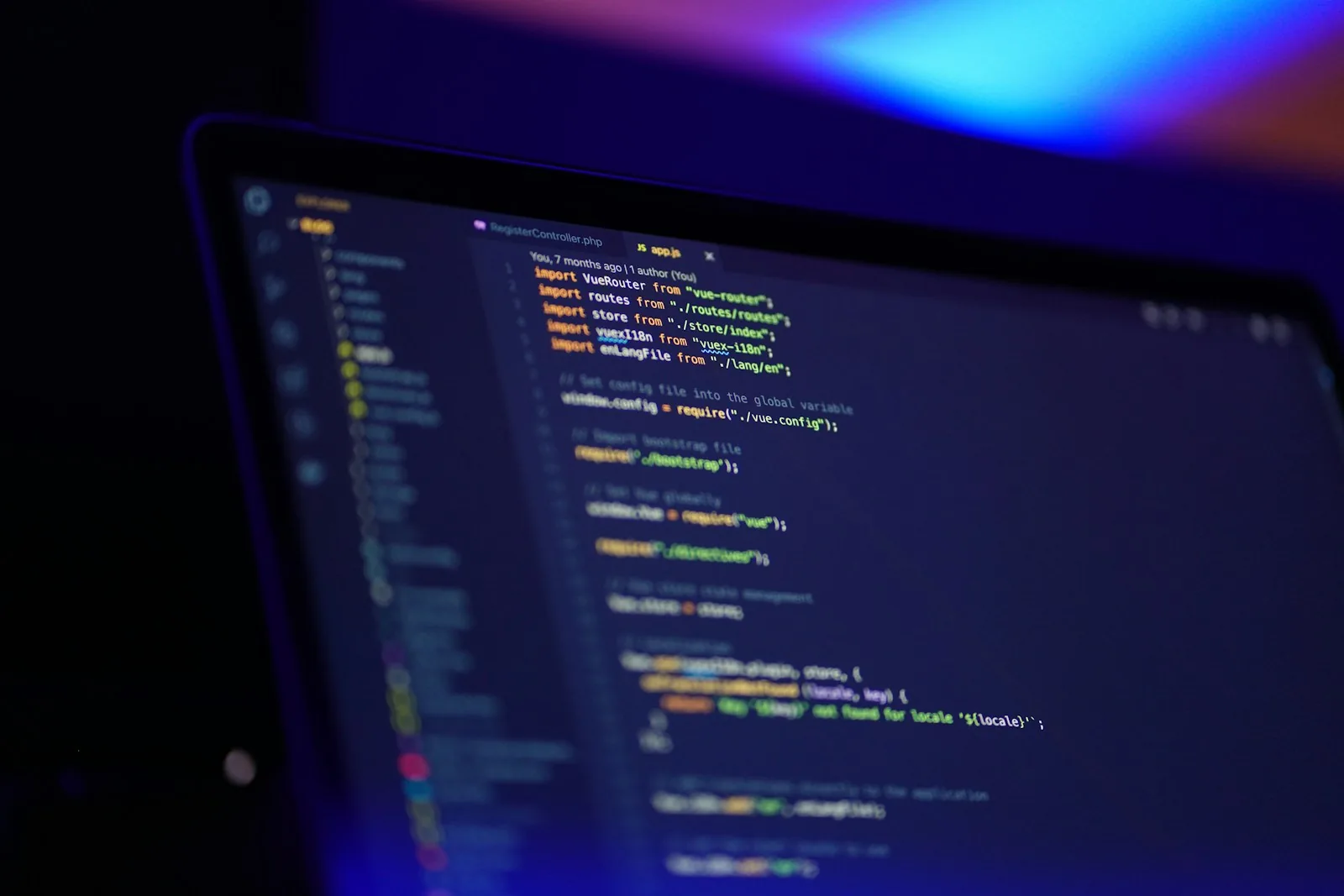 A laptop screen displaying application source code.