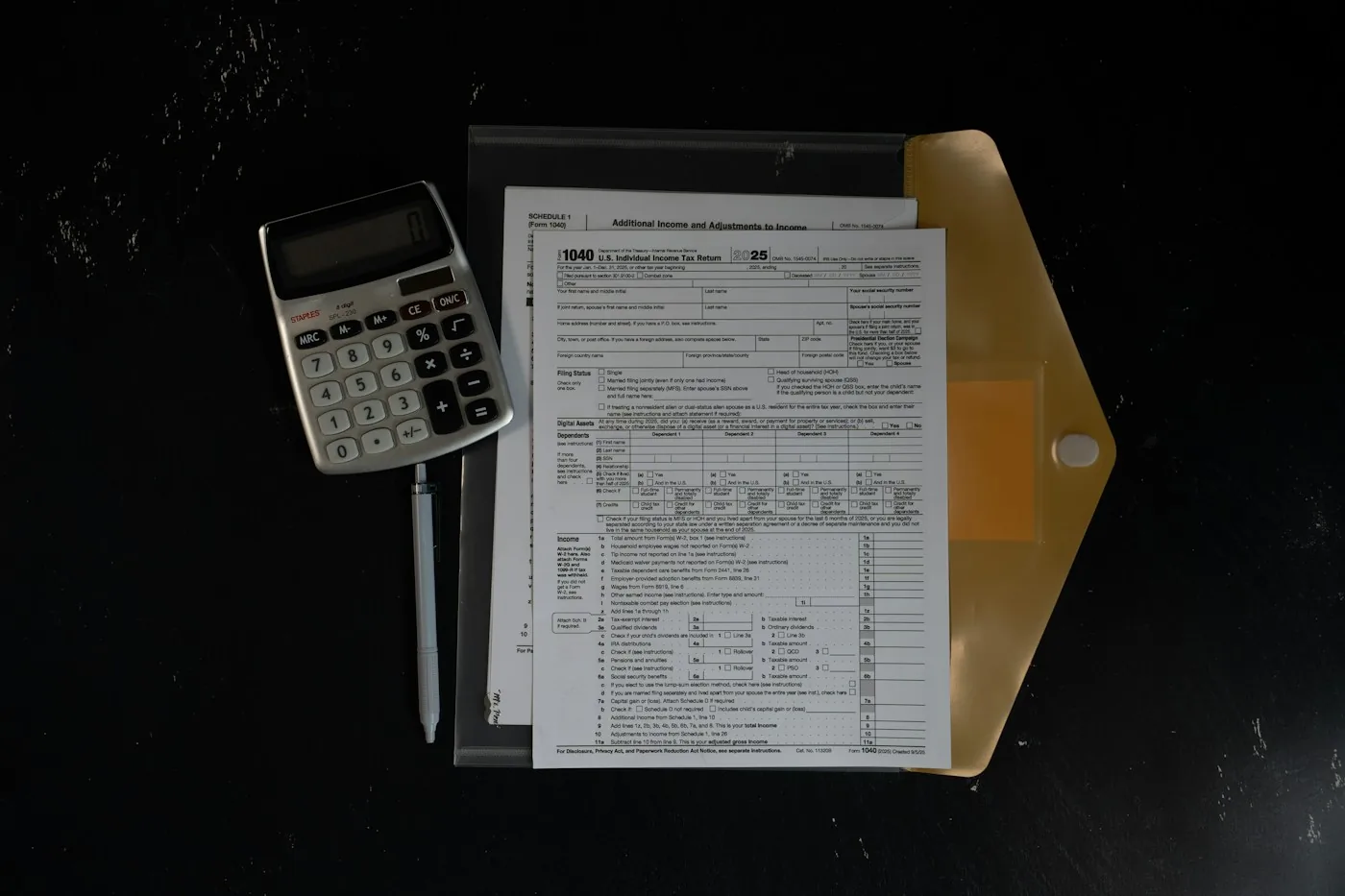 A calculator beside financial paperwork.