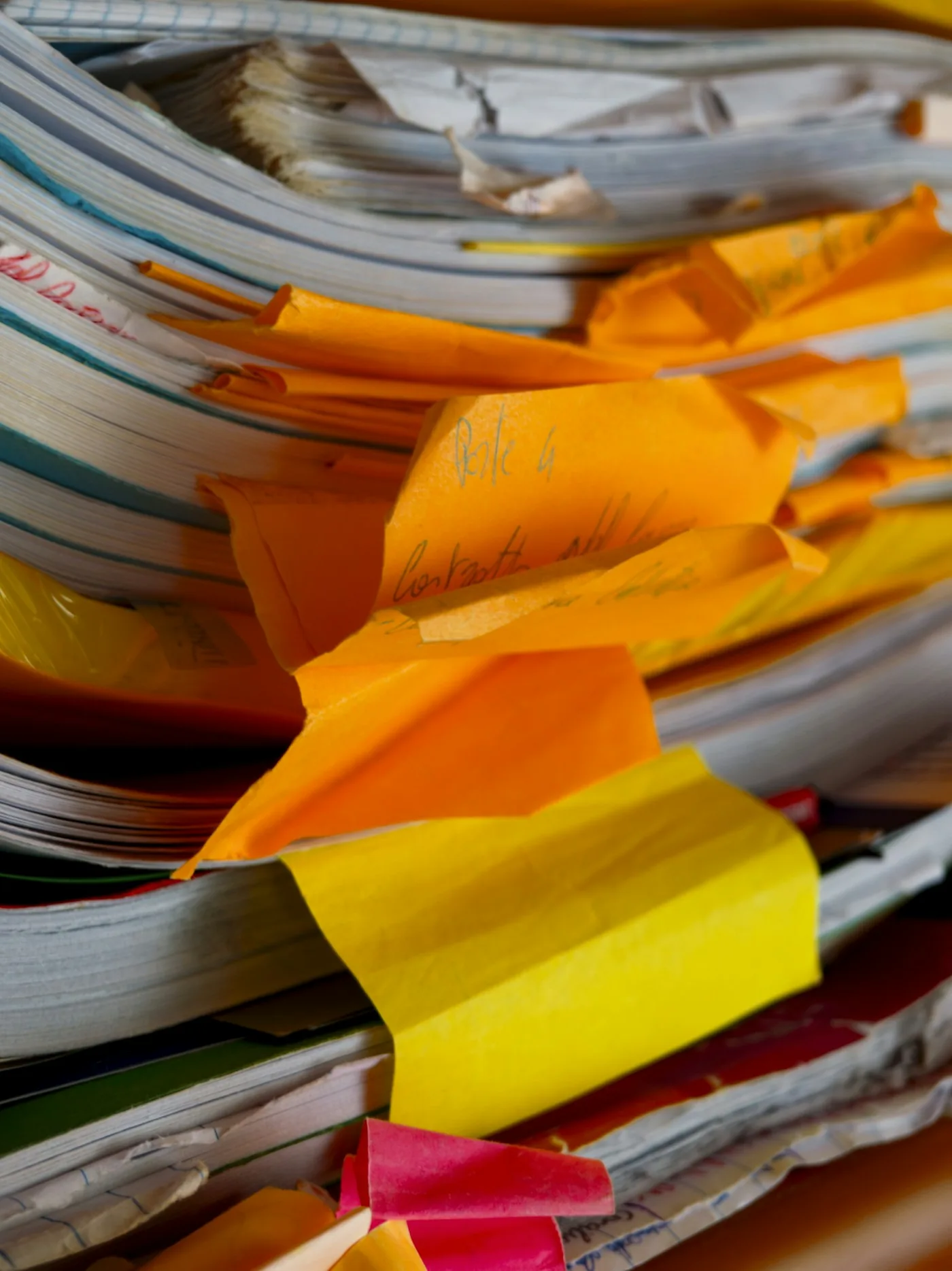 Stacks of paperwork with notes and folders.
