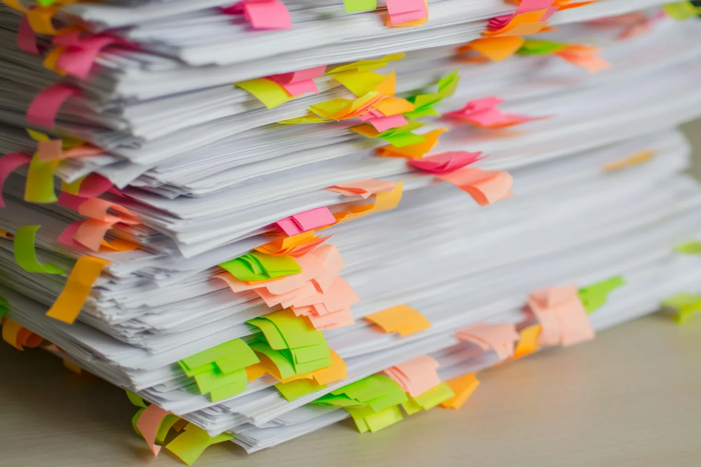 A stack of documents marked with review tabs.