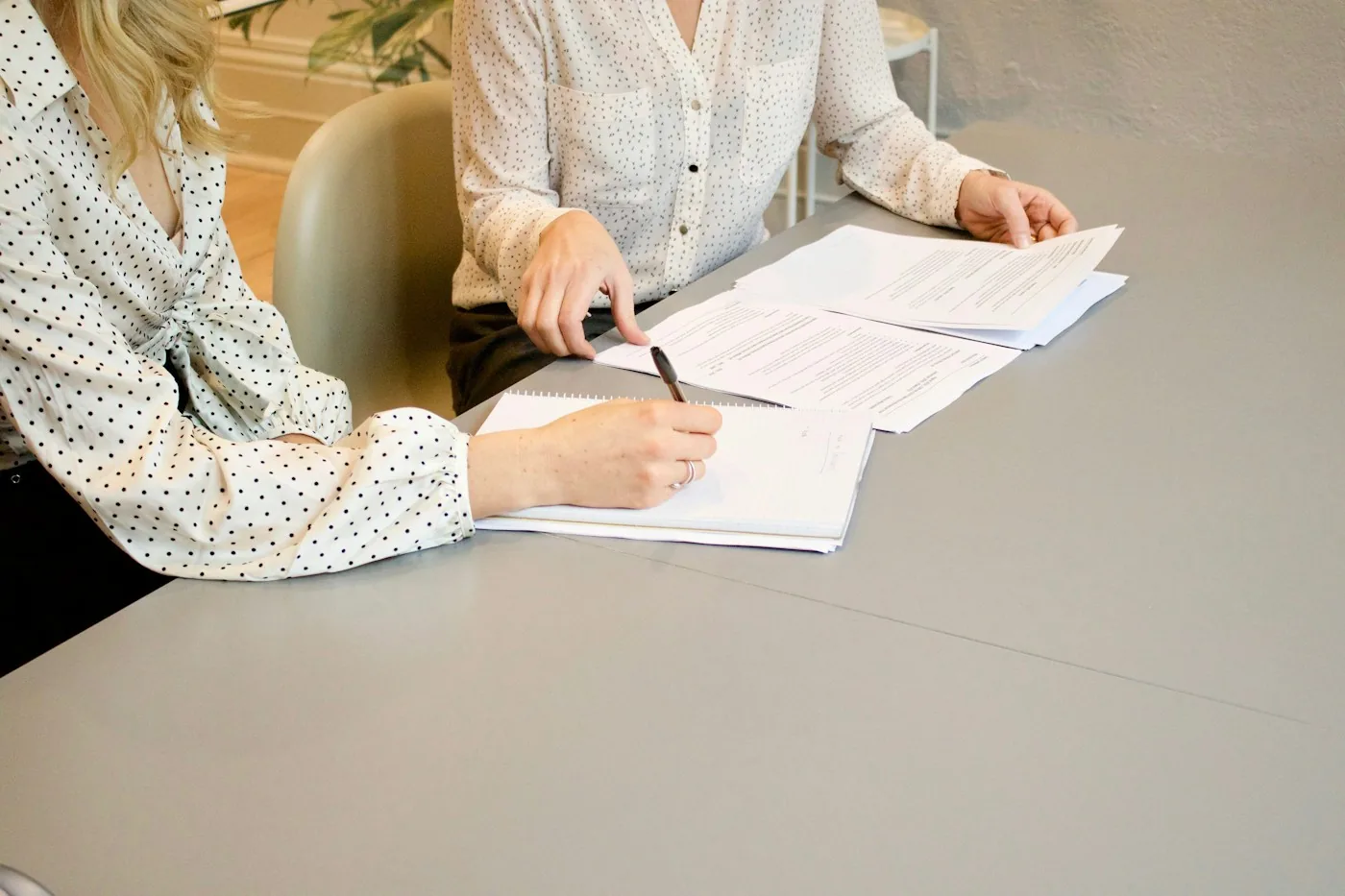 A professional reviewing and signing a document.