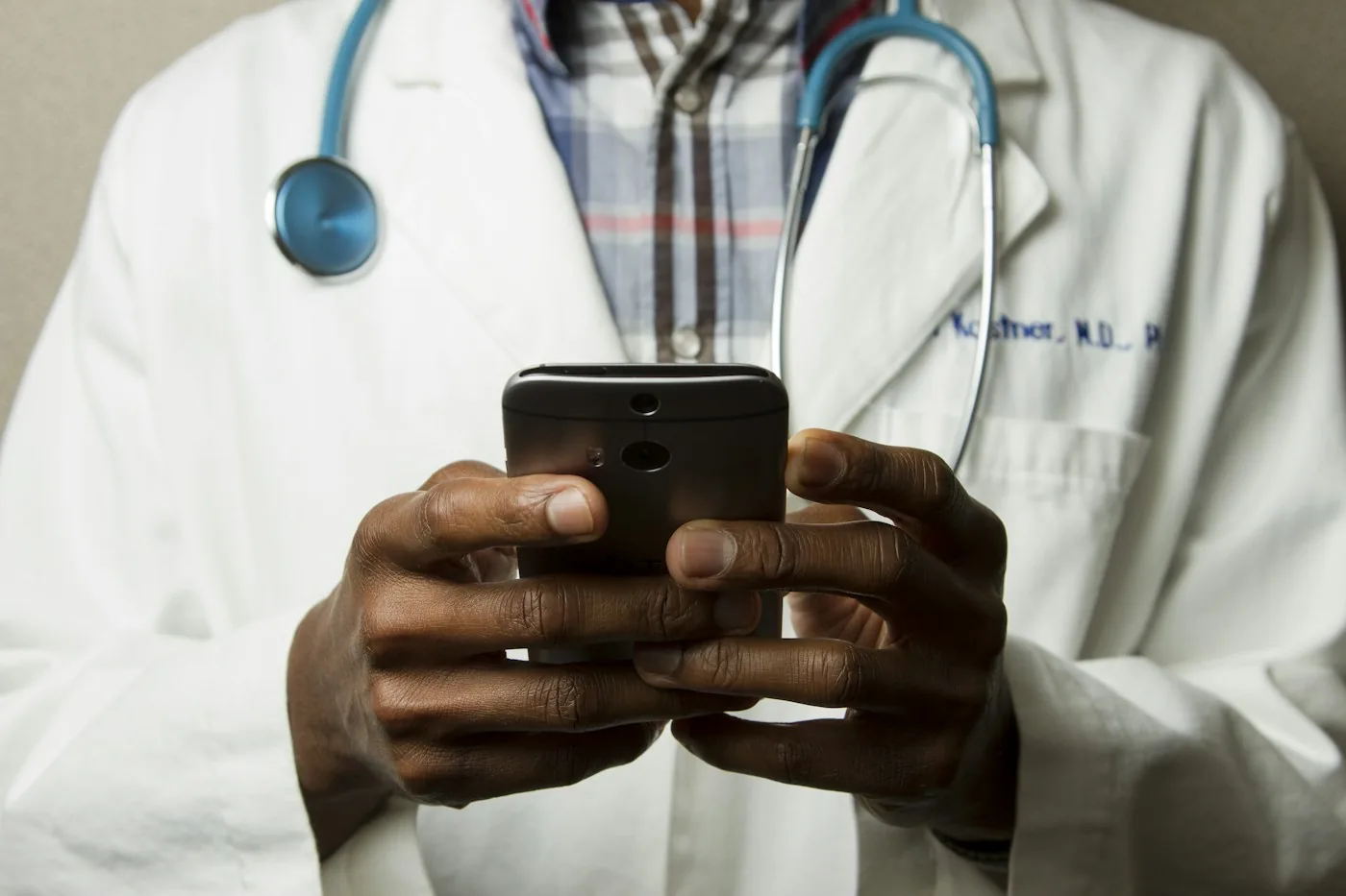 A healthcare professional using a smartphone.
