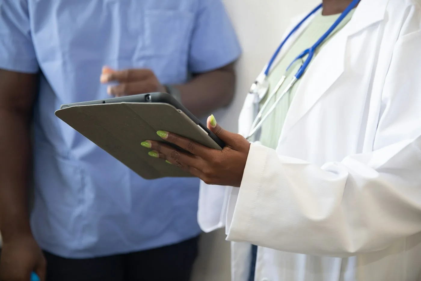 Healthcare professionals reviewing information on a tablet.