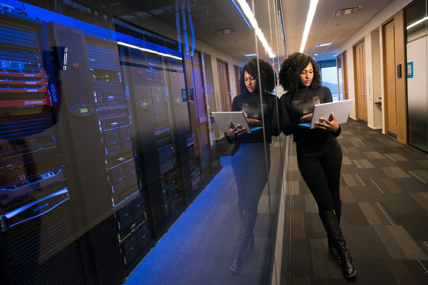 Two technology professionals inspecting data-center equipment.
