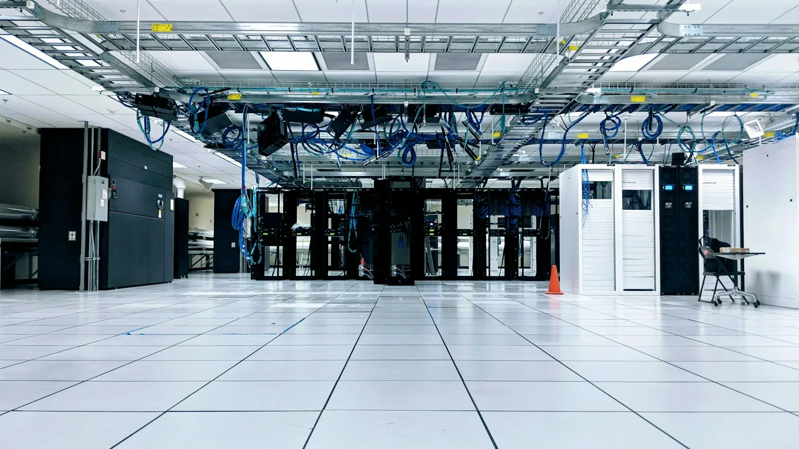 A wide aisle between server racks in a data center.