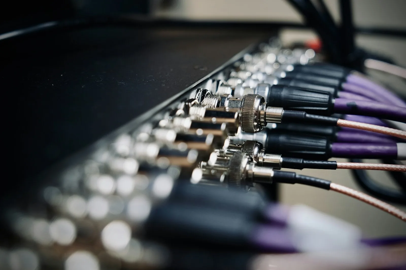 A row of cables connected to networking equipment.