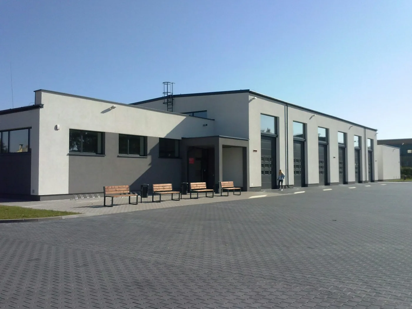 An industrial warehouse building and loading area.