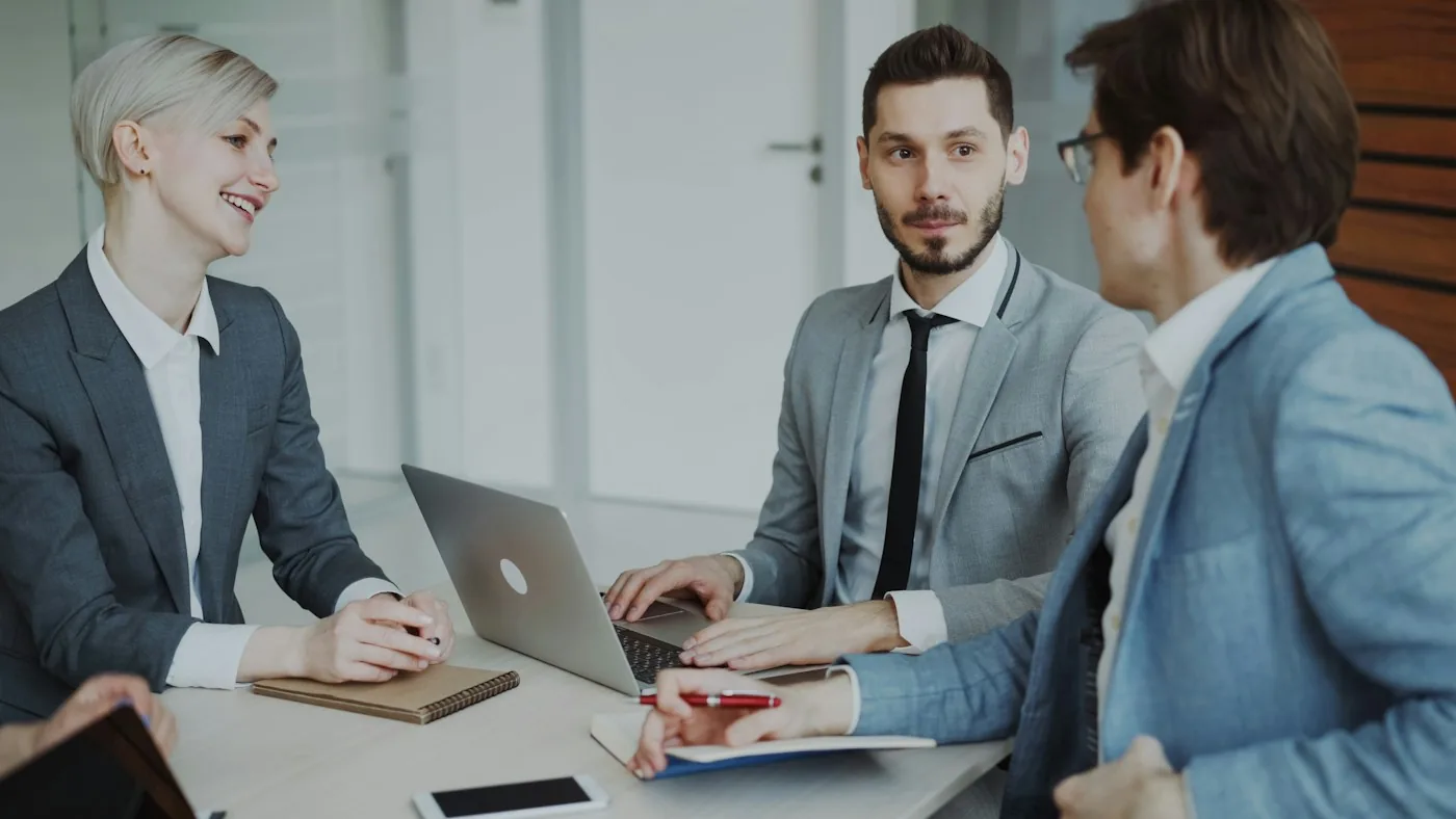 Business professionals reviewing a plan in a meeting.