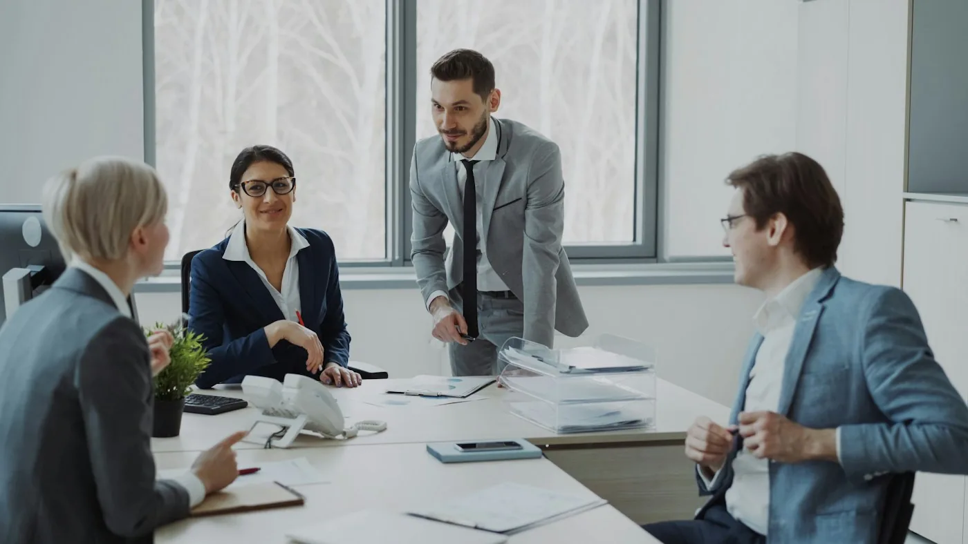 Business colleagues reviewing a proposal in a meeting.