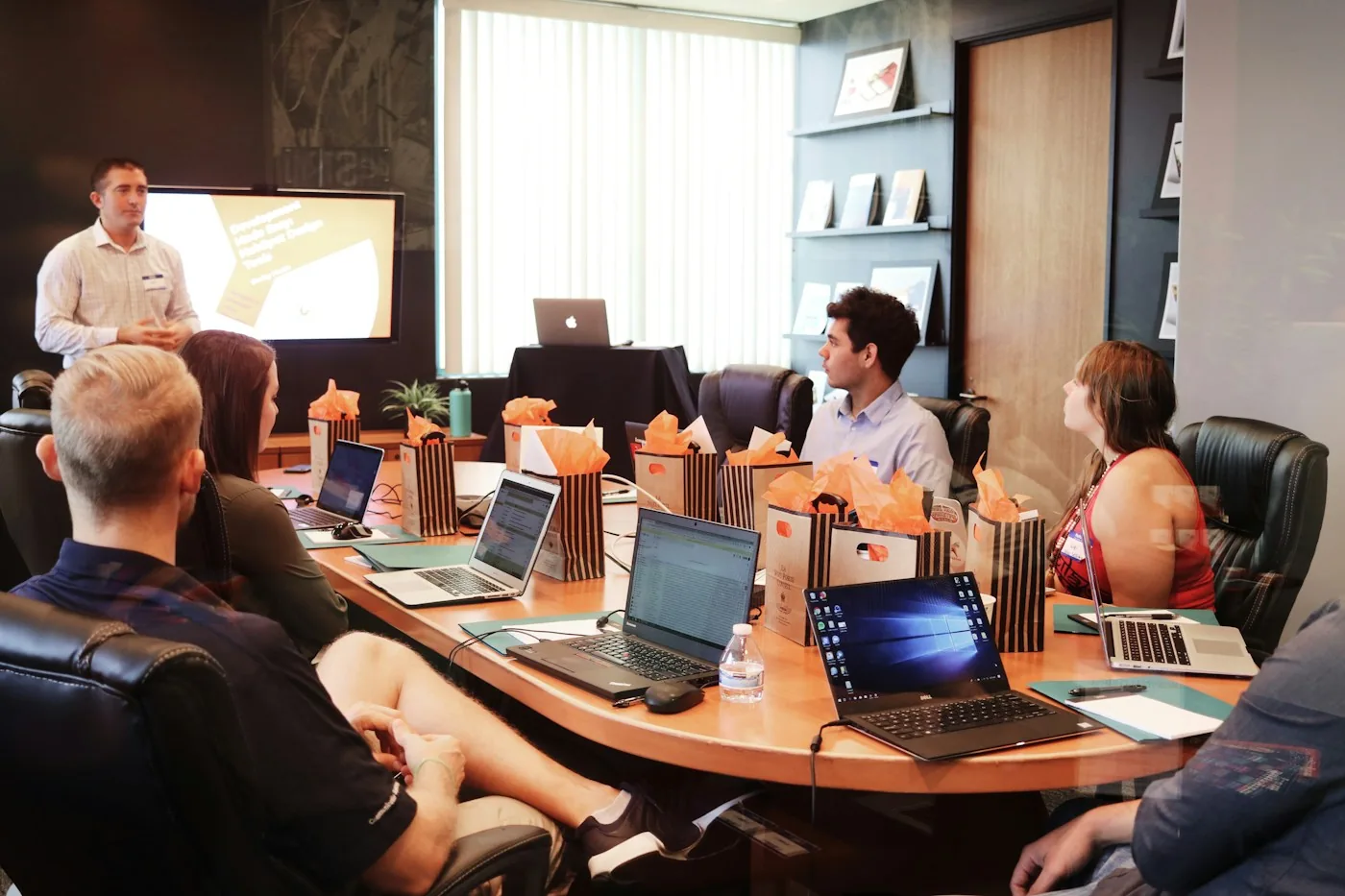 A team reviewing a presentation and project plans.