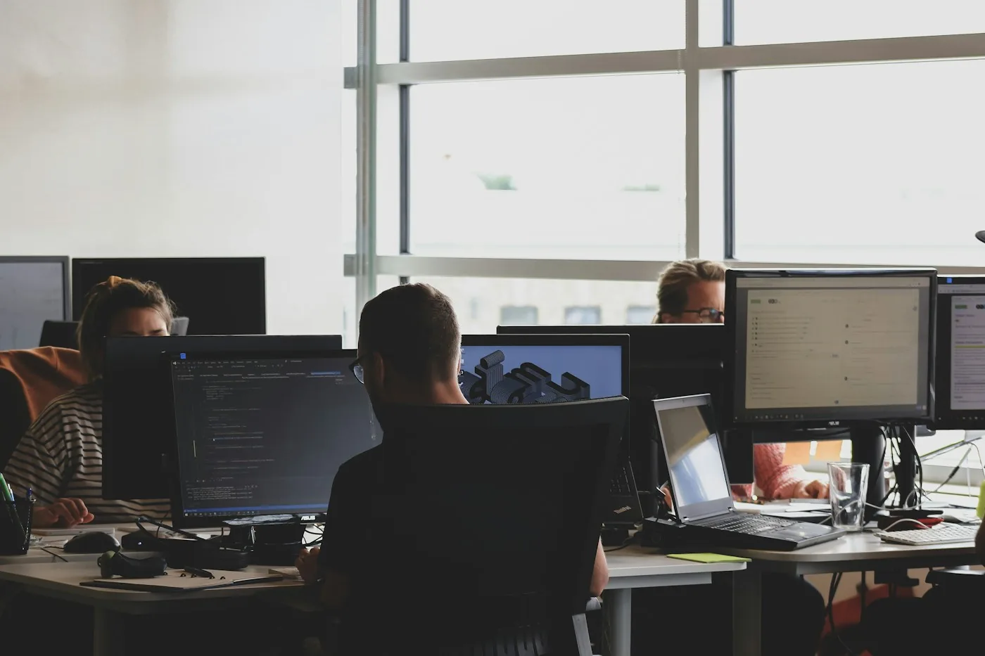 Developers working at computer monitors in an office.